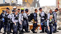Search and rescue team members depart after working the debris field of the Champlain Towers South