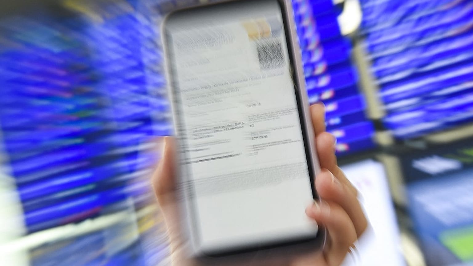 A woman shows her EU Digital Covid certificate on her mobilephone