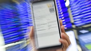 A woman shows her EU Digital Covid certificate on her mobilephone