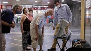 Elderly people look at a voting machine presented by Central Election Commission in Sofia