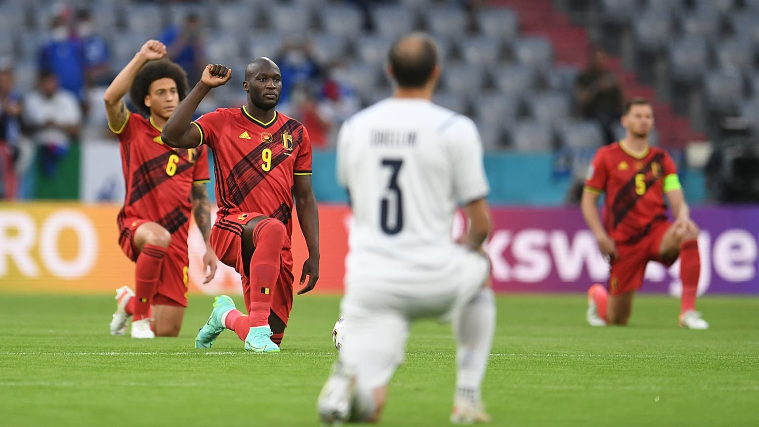 Players take a knee before a Euro 2020 match between Belgium and Italy.