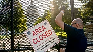 Barricades come down on US Capitol as threat level lowered