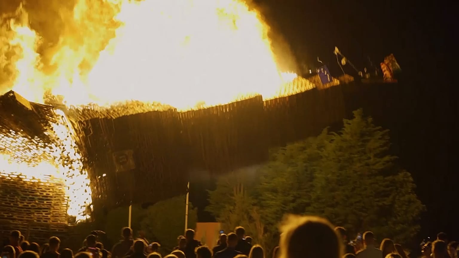 The pyre burning and crashing down in a ball of fire