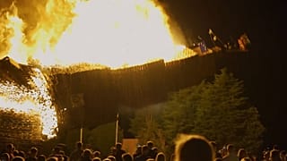 The pyre burning and crashing down in a ball of fire