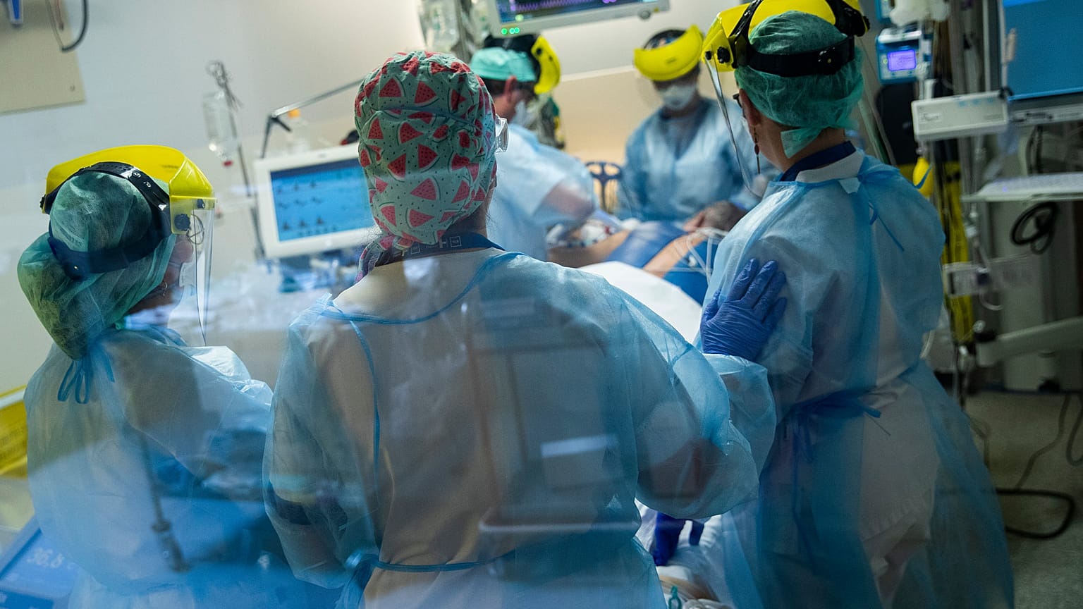Medical staff tend to a COVID-19 patient in the intensive care ward of the Erasme hospital in Brussels, April 28, 2021.