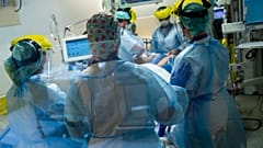 Medical staff tend to a COVID-19 patient in the intensive care ward of the Erasme hospital in Brussels, April 28, 2021.