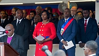 Haiti's President Jovenel Moise stands with his wife Martine during a Mass