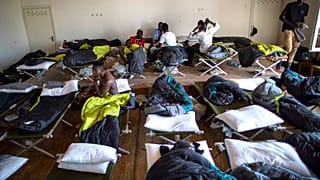 Migrants from Cameroon rest at the refugee camp in the village of Vydeniai, Lithuania, Saturday, July 10, 2021. 