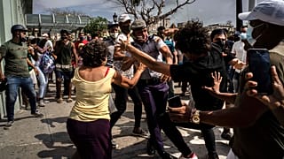 Police scuffle and detain an anti-government demonstrator during a protest in Havana, Cuba, Sunday July 11, 2021.