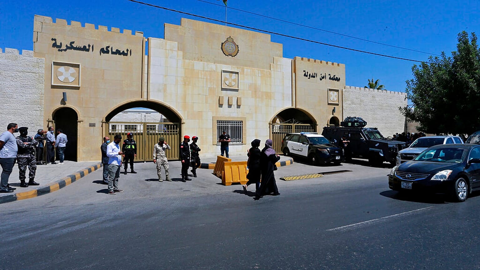 Security forces stand outside the state security court where the trial of Bassem Awadallah and Sharif Hassan bin Zaid takes place  in Amman, Jordan, 21 June, 2021.  