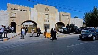 Security forces stand outside the state security court where the trial of Bassem Awadallah and Sharif Hassan bin Zaid takes place  in Amman, Jordan, 21 June, 2021.  