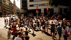 People wearing a face mask to protect against the spread of coronavirus walk along a street in downtown Barcelona, Spain, Saturday, July 3, 2021. 