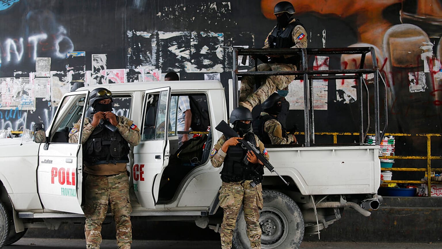 Police stand guard under an overpass in Port-au-Prince, Haiti, Monday, July 12, 2021. 