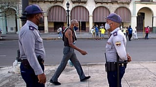 Police stand guard near the National Capitol building in Havana, Cuba, Monday, July 12, 2021