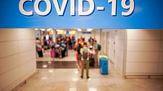 n this Aug.16, 2020 file photo, vacationers arriving in Rome from four Mediterranean countries, Croatia, Greece, Malta and Spain, line up with their suitcases at Rome airport.
