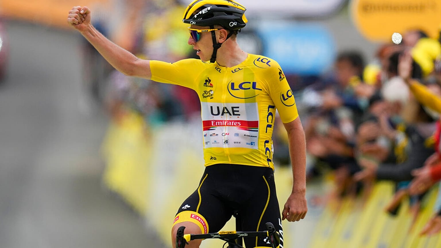 Slovenia's Tadej Pogacar, wearing the overall leader's yellow jersey