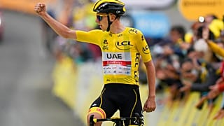 Slovenia's Tadej Pogacar, wearing the overall leader's yellow jersey