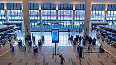 Passengers move about a spacious Terminal B of New York's LaGuardia Airport