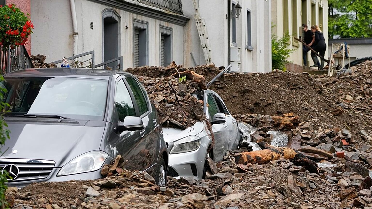 Cars are covered in Hagen, Germany, Thursday, July 15, 2021 with the debris brought by the flooding of the 'Nahma' river the night before. 