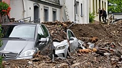 Cars are covered in Hagen, Germany, Thursday, July 15, 2021 with the debris brought by the flooding of the 'Nahma' river the night before. 