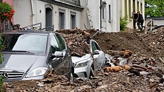 Cars are covered in Hagen, Germany, Thursday, July 15, 2021 with the debris brought by the flooding of the 'Nahma' river the night before. 