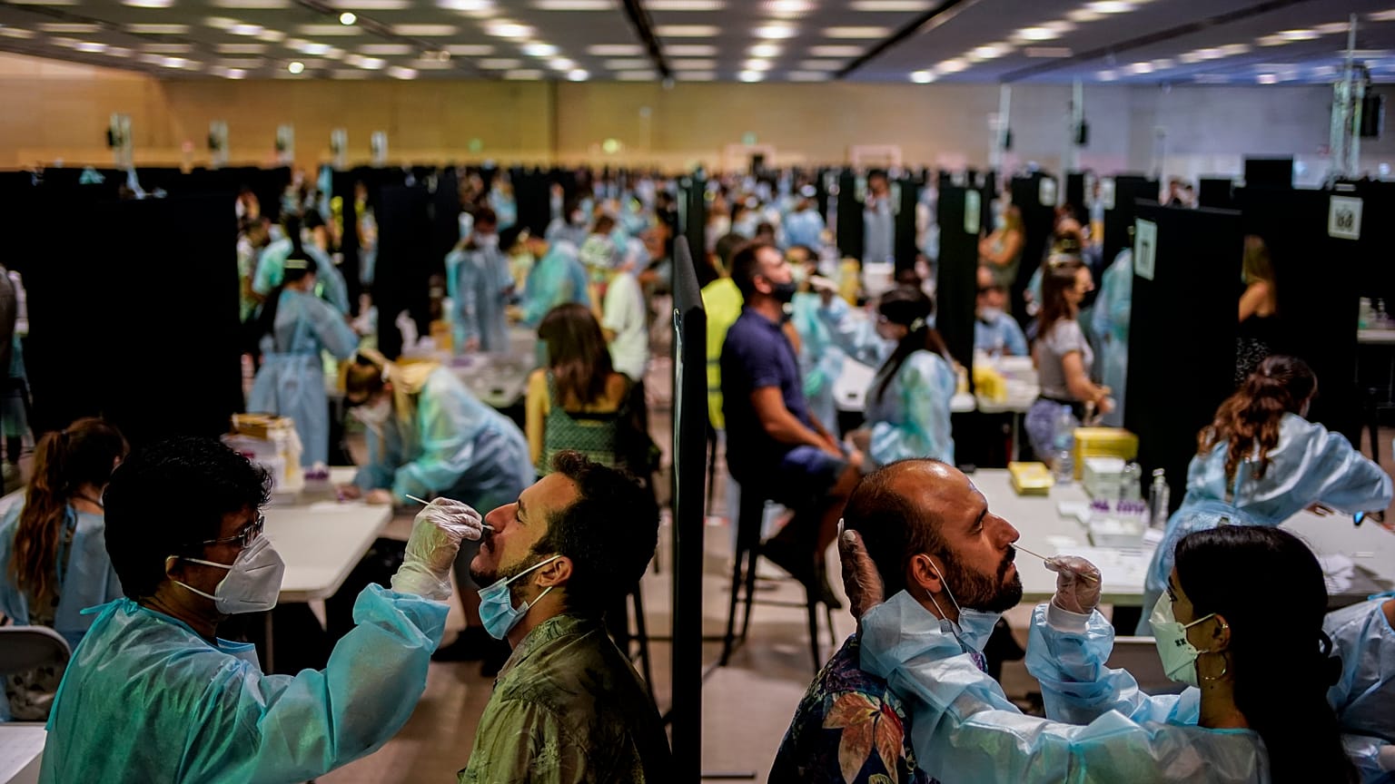 Health workers take swab samples collection for a Covid-19 antigen test ahead of the Cruilla music festival in Barcelona, Spain, July 9, 2021. 