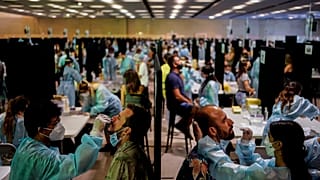 Health workers take swab samples collection for a Covid-19 antigen test ahead of the Cruilla music festival in Barcelona, Spain, July 9, 2021. 