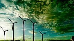 Wind turbines under a moody sky.