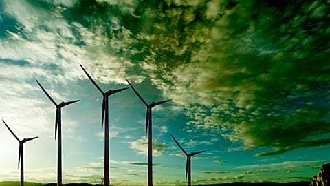 Wind turbines under a moody sky.