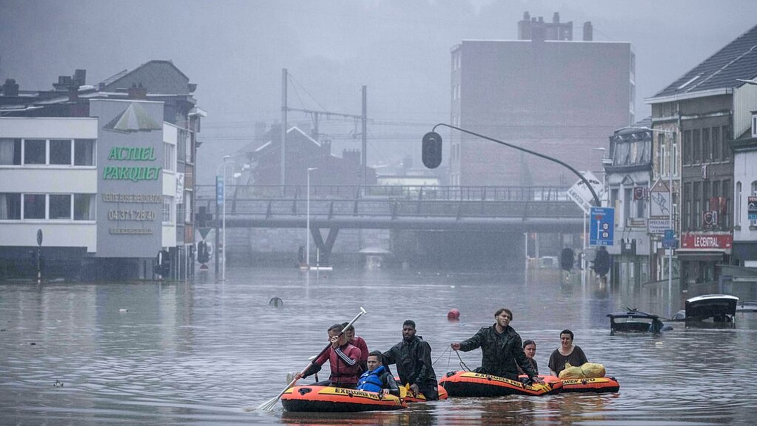 People use rubber rafts in floodwaters after the Meuse River broke its banks during heavy flooding in Liege, Belgium, Thursday, July 15, 2021.