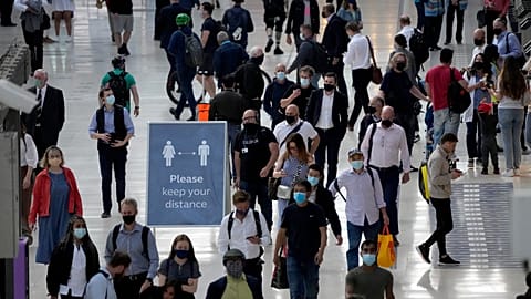 People wear face masks to curb the spread of coronavirus during the morning rush hour at Waterloo train station in London, July 14, 2021.