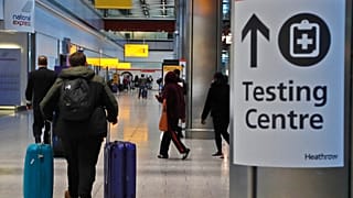 Travellers walk towards the Covid-19 testing centre at Heathrow Airport in London, Sunday, Jan. 17, 2021.