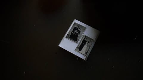 Old wedding photo floating in floodwater in a basement