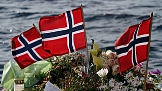 Norwegian flags and flowers are laid in Sundvollen, close to Utoya island in 2011.