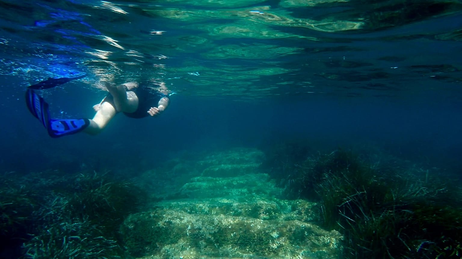 Cyprus Antiquities Department official Yiannis Violaris snorkels over submerged stone remains of the ancient harbour near Amathus ancient city, Cyprus, on July 1, 2021