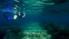 Cyprus Antiquities Department official Yiannis Violaris snorkels over submerged stone remains of the ancient harbour near Amathus ancient city, Cyprus, on July 1, 2021
