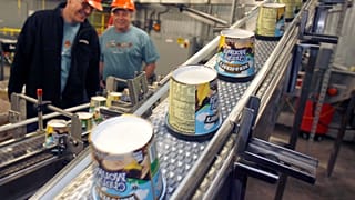 Ice cream moves along the production line at Ben & Jerry's Homemade Ice Cream, in Waterbury, Vt.