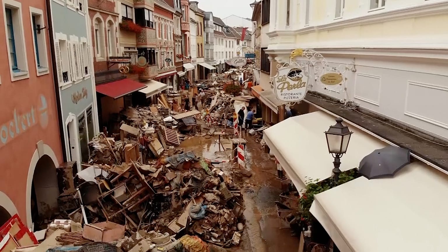 Piles of muddy debris in streets
