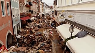 Piles of muddy debris in streets