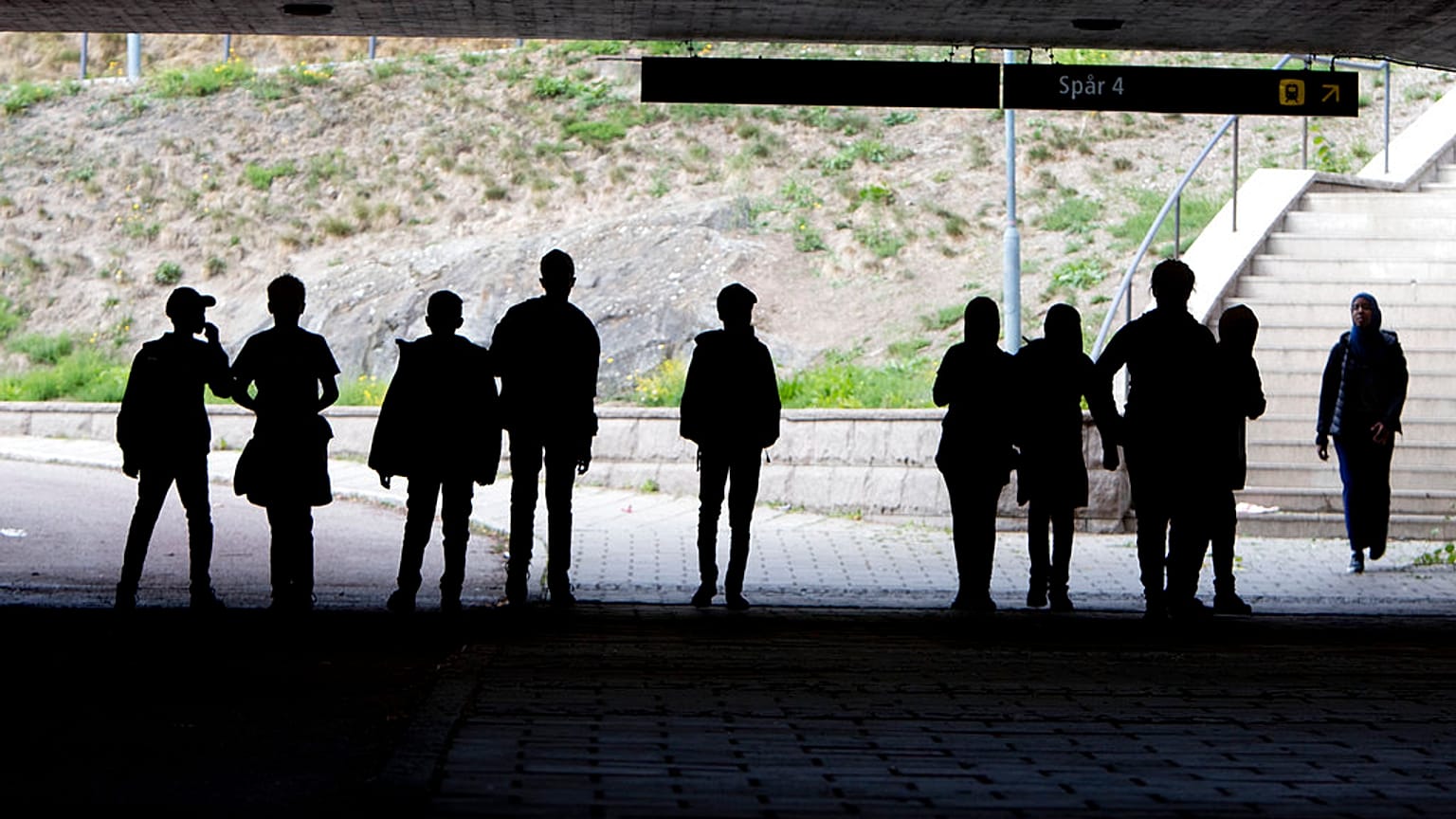 Asylum seeker children pose under a railway bridge in Flen, about 100km south of Stockholm, in August 2018.