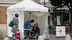 A medical technician administers nasal swabs at a mobile testing site in Versailles, west of Paris, Thursday, July 15, 2021.