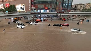 Vehicles are stranded after a heavy downpour in Zhengzhou city, central China