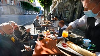 People enjoy a breakfast at a café terrace Wednesday, May, 19, 2021 in Strasbourg, eastern France.