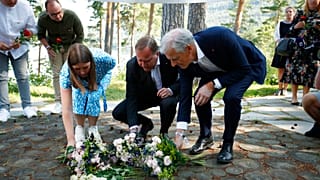 Astrid Hoem, leader of the AUF in Norway, Prime Minister of Sweden Stefan Lofven and Labor Party leader Jonas Gahr Store lay flowers at Utøya