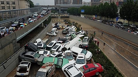 Flood aftermath: Pile up of cars on road in China