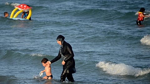 A Tunisian woman wearing a "burkini", a full-body swimsuit designed for Muslim women