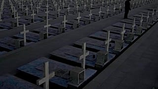 A man stands by the graves of soldiers killed in the 1974 Turkish invasion of Cyprus in the Tymvos Macedonitissas military cemetery 