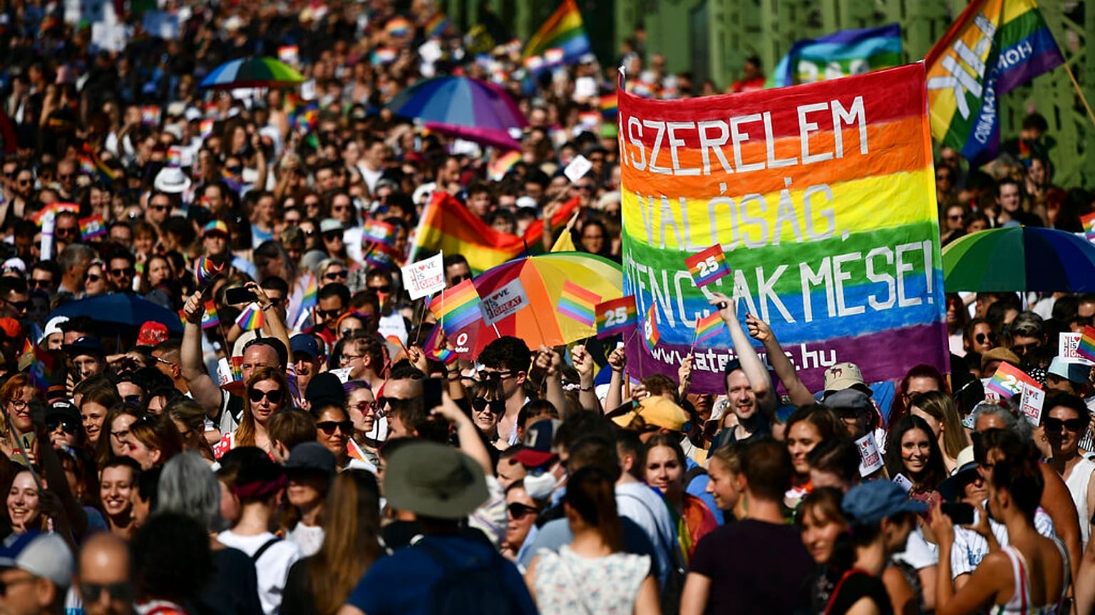 People march across a Bridge over the River Danube in downtown Budapest during a gay pride parade in Budapest, July 24, 2021. 
