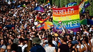 People march across a Bridge over the River Danube in downtown Budapest during a gay pride parade in Budapest, July 24, 2021. 