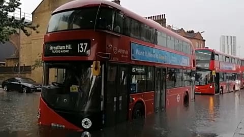 Cars and buses stuck as London roads flood in storm